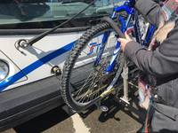 Extend and lift the hook arm as high as possible over the front tire of your bike. Make sure it is not touching the bike fender or lock.